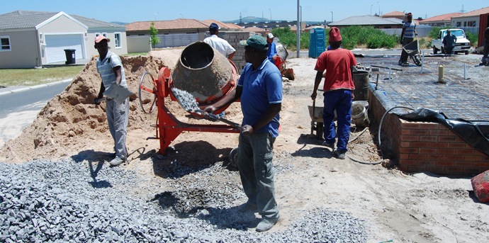 workers mixing concrete
